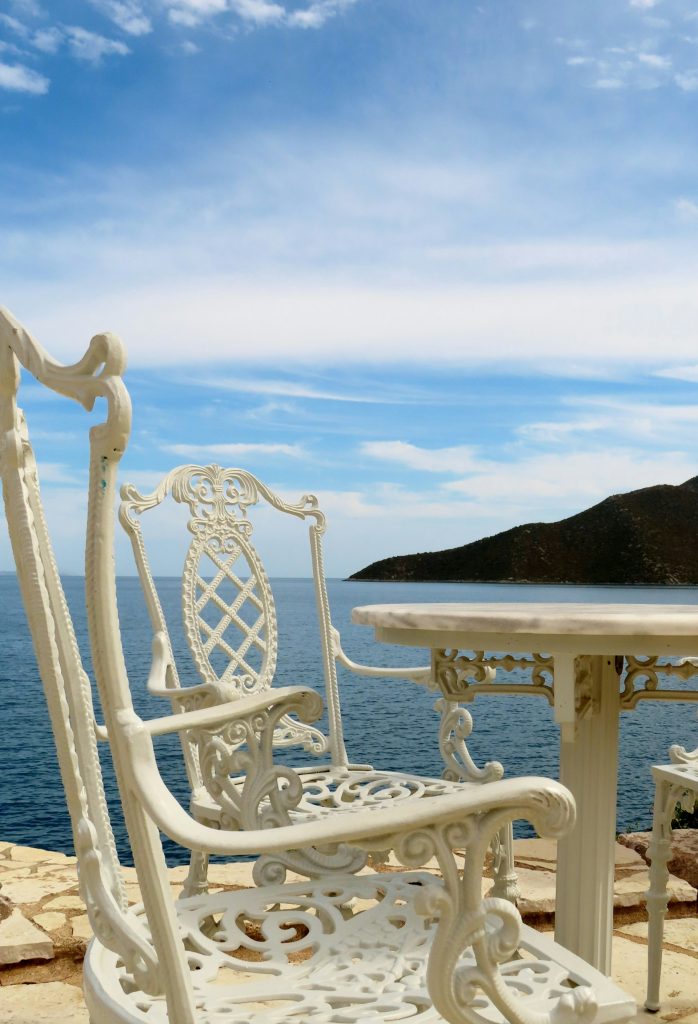 the quiet joys of traveling alone empty coastal cafe table terrace