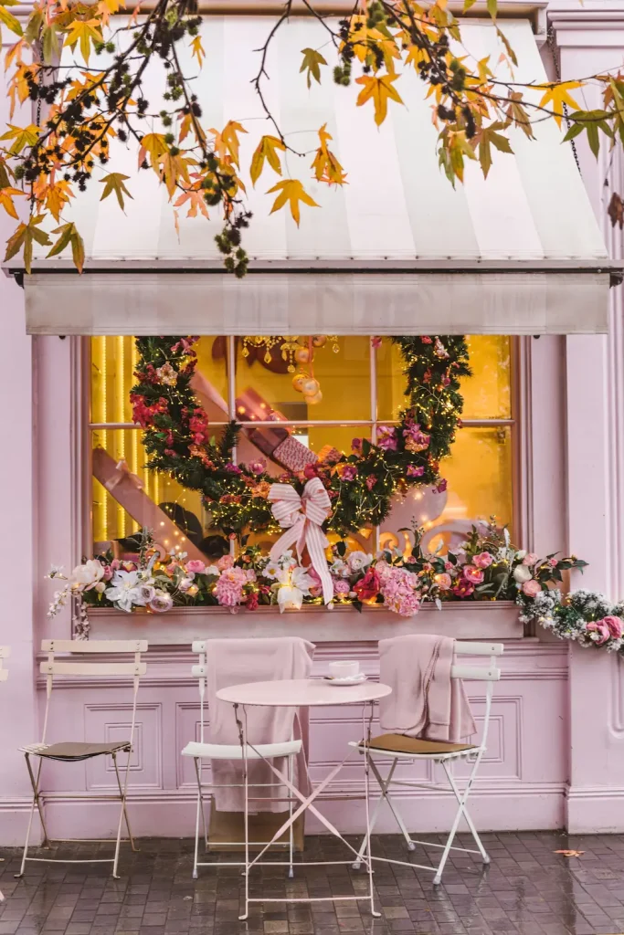 A tiered stand of dainty cakes and a teapot in an elegant London tearoom, illustrating the best afternoon tea in London for women over 50.