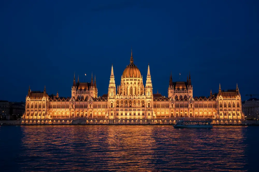 The Hungarian Parliament glowing over the Danube in Budapest, illustrating safe and elegant Budapest solo travel for women over 50.
