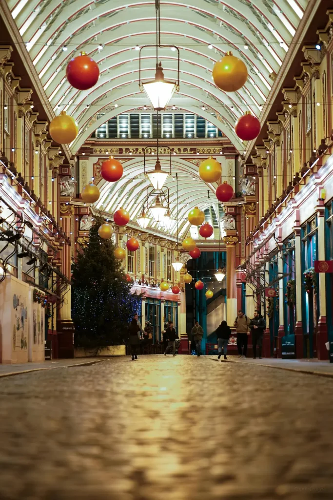 Twinkling lights and wooden stalls at a London Christmas market by the river, illustrating London Christmas markets for women over 50.