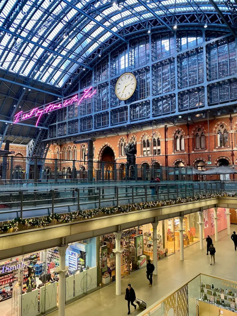 A sleek Eurostar train at the platform beneath a grand glass station roof, illustrating the London to Paris train for women over 50.