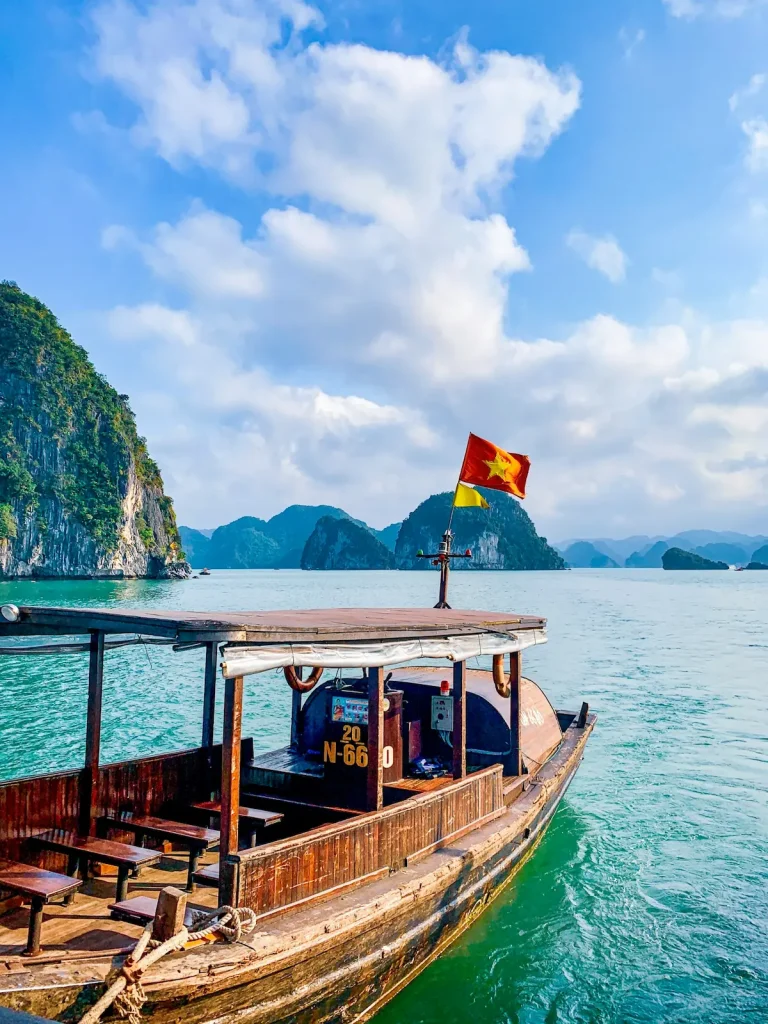 Traditional wooden boats on the emerald water of Halong Bay, Vietnam, illustrating safe and elegant Vietnam solo travel for women over 50.