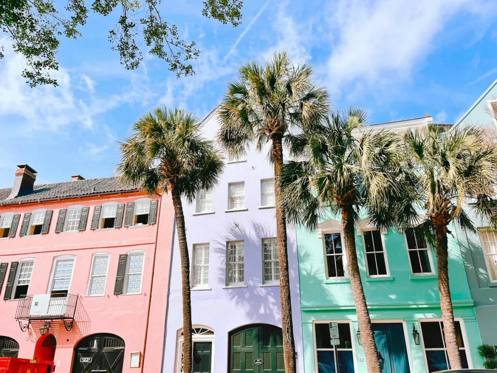 Solo travel Charleston — the pastel houses of Rainbow Row along a cobblestone street in the historic district