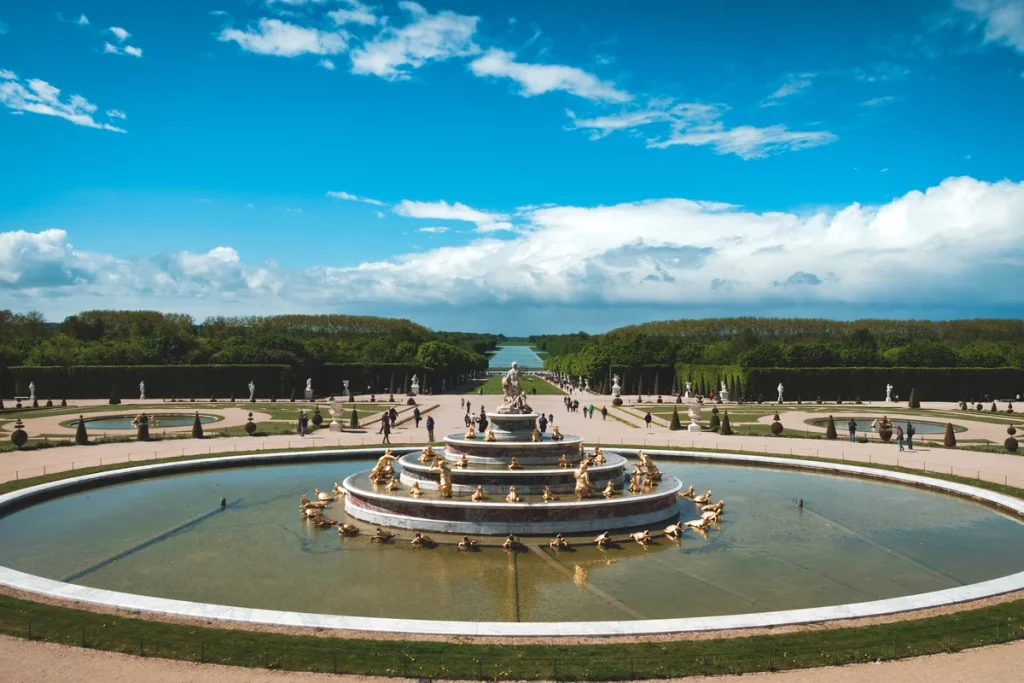 The Latona Fountain and formal gardens of the Palace of Versailles stretching toward the Grand Canal, one of the best day trips from Paris for women over 50